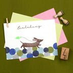 Invitation card with a dog illustration and colorful circles on a green background