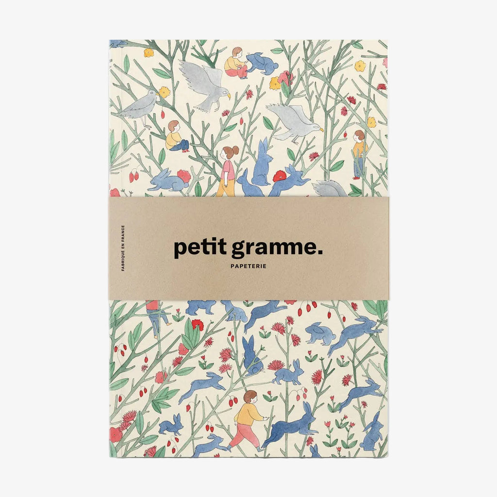 Notebook with a colorful animal pattern and 'petit gramme' branding on a white background