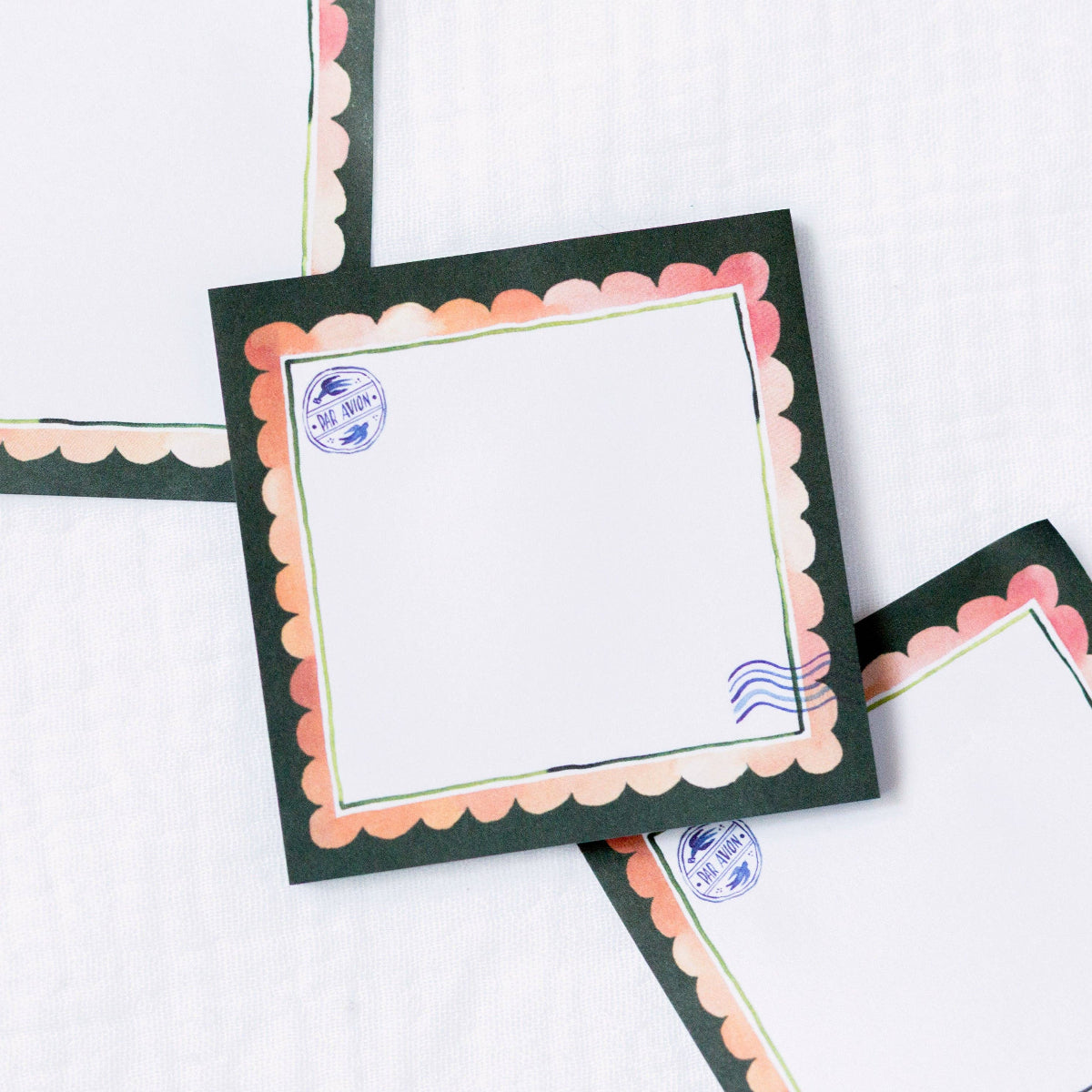 Decorative sticky notes with scalloped edges and postage stamp designs on a white background