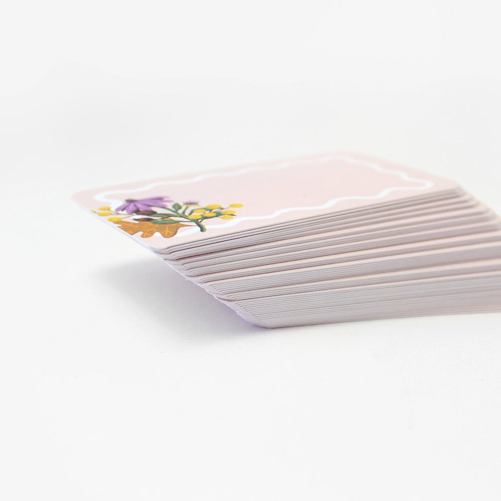 Stack of cards with floral design on a white background