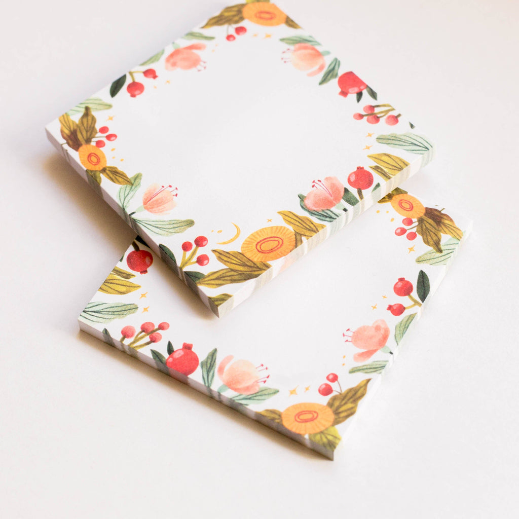 Two floral-patterned sticky notes stacked on a white background