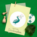 Card with a pelican illustration and text on a green background