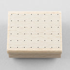 Wooden stamp with a square of dots on a gray background