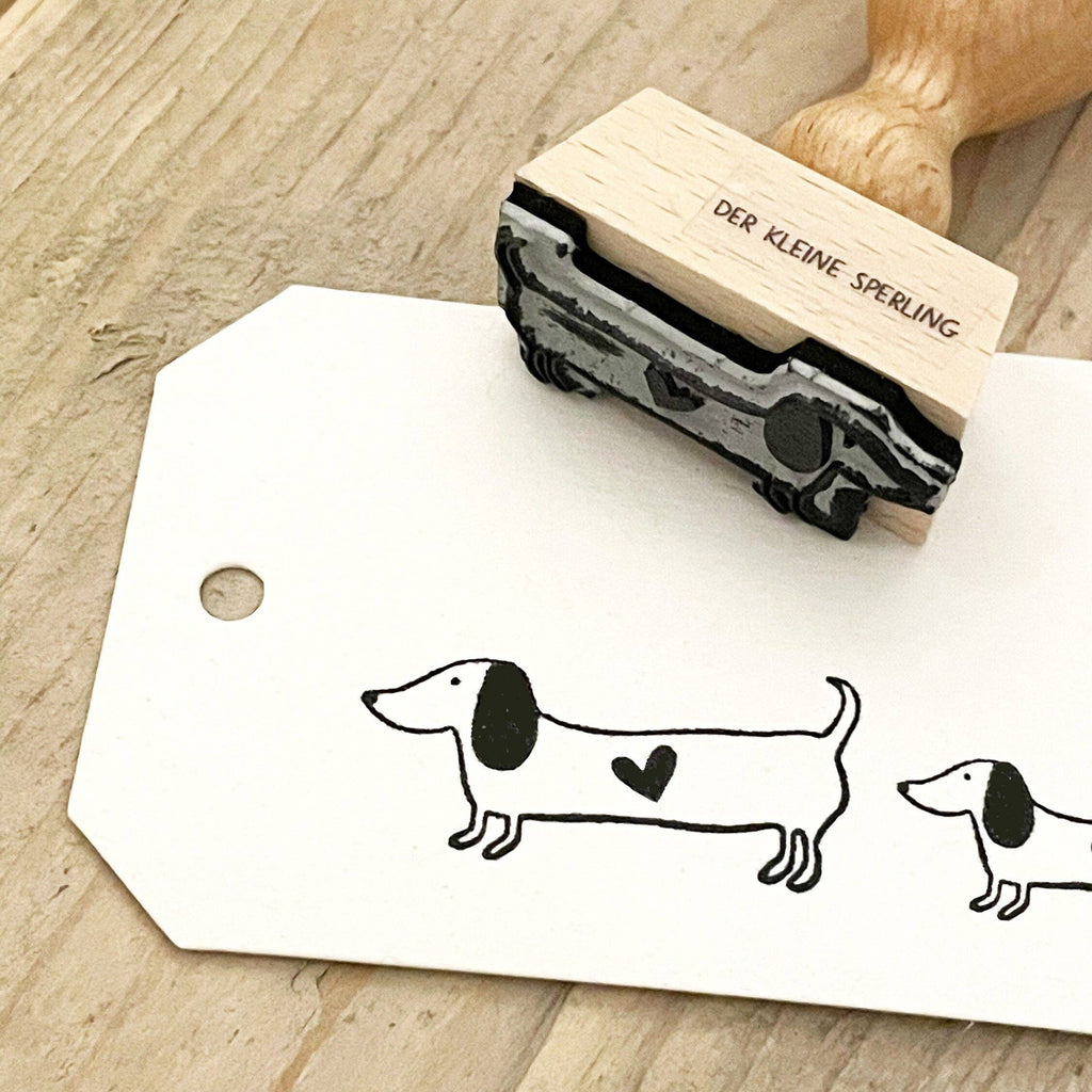Rubber stamp with dachshund design on a wooden surface