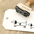 Rubber stamp with dachshund design on a wooden surface
