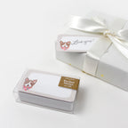 Pocket notes with dog illustration in a clear box on a white background