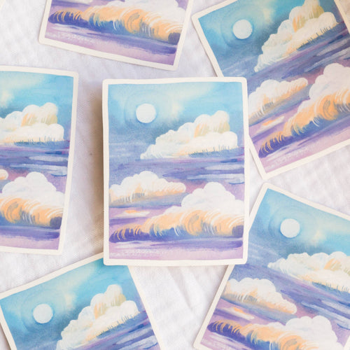 A vinyl sticker with cloud and moon designs on a textured surface