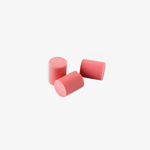 Three pink cylindrical eraser refills on a white background