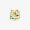 A die-cut sticker featuring the quote 'HOW LOVELY IS THE SILENCE OF GROWING THINGS.' in green and yellow lettering, surrounded by watercolor-style green leaves, yellow flowers, and small white dots on a white background.