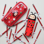 Two red pencil cases with ladybug design surrounded by red ladybug pens on a light grey background