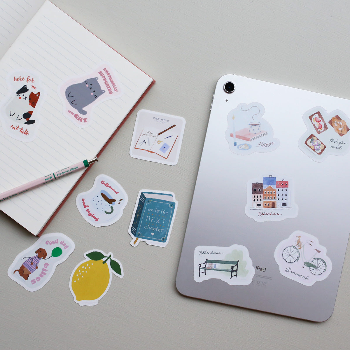 Collection of decorative vinyl stickers on a tablet and notebook