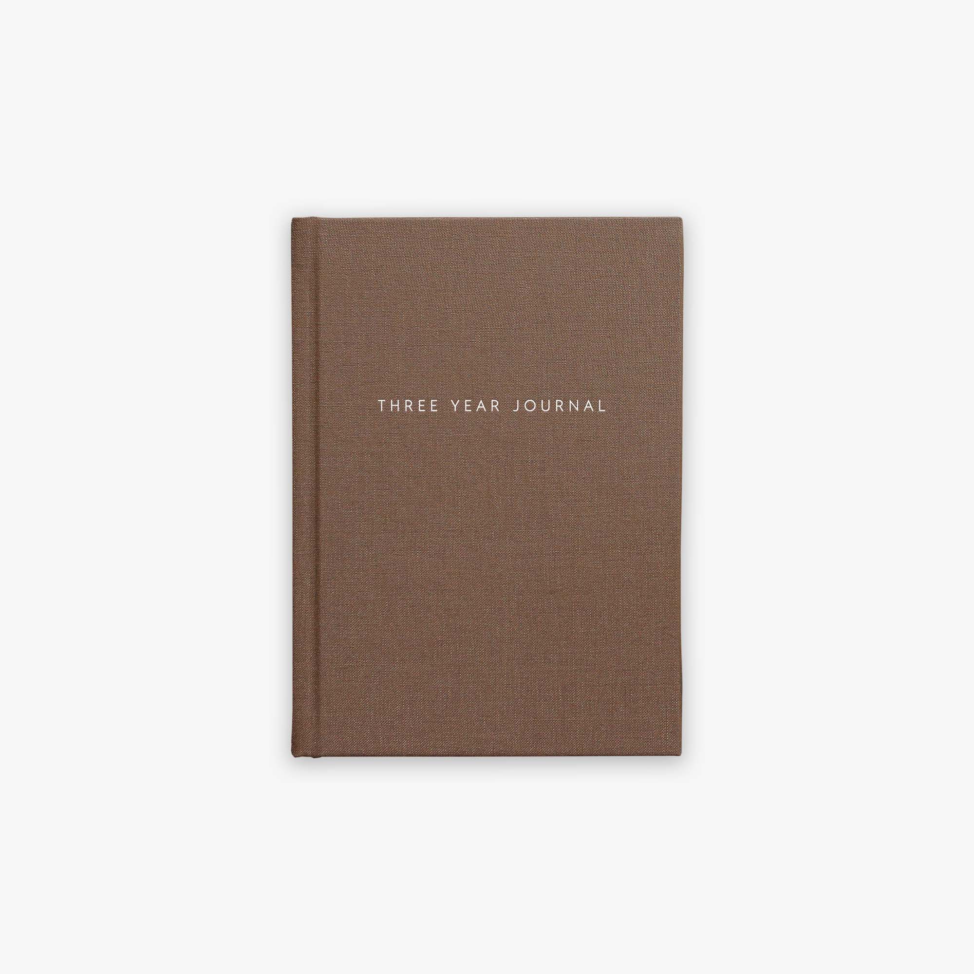 Brown guided journal titled 'Three Year Journal' on a white background