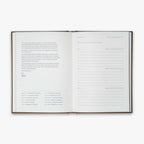 Open book from our Three Year Journal with short description of the purpose of the book and the daily prompts on a white background