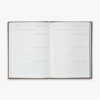 Open book from our Three Year Journal (Treårsdagbogen) with the daily prompts on a white background