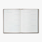 Open book from our Three Year Journal (Treårsdagbogen) with the daily prompts on a white background