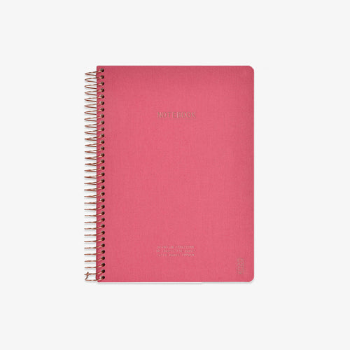 Pink notebook with spiral binding on a white background