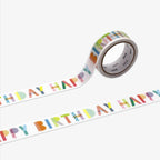 Roll of decorative tape with 'Happy Birthday' text in colorful letters on a white background