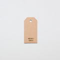 Kraft gifttag with 'MERRY XMAS' text on a light gray background