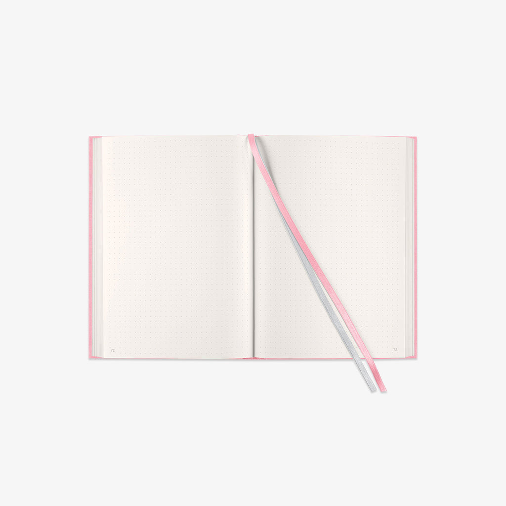 Open notebook with a pink and grey ribbon
