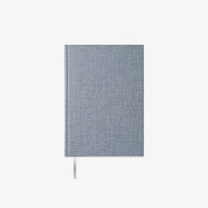 Blue fabric-bound notebook on a white background