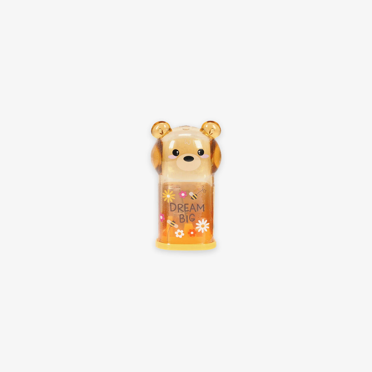 Bear-shaped pencil sharpener with the tex' dream big' on a grey background