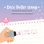 Decorative roller stamp with pink ink pad and cat design on a white background