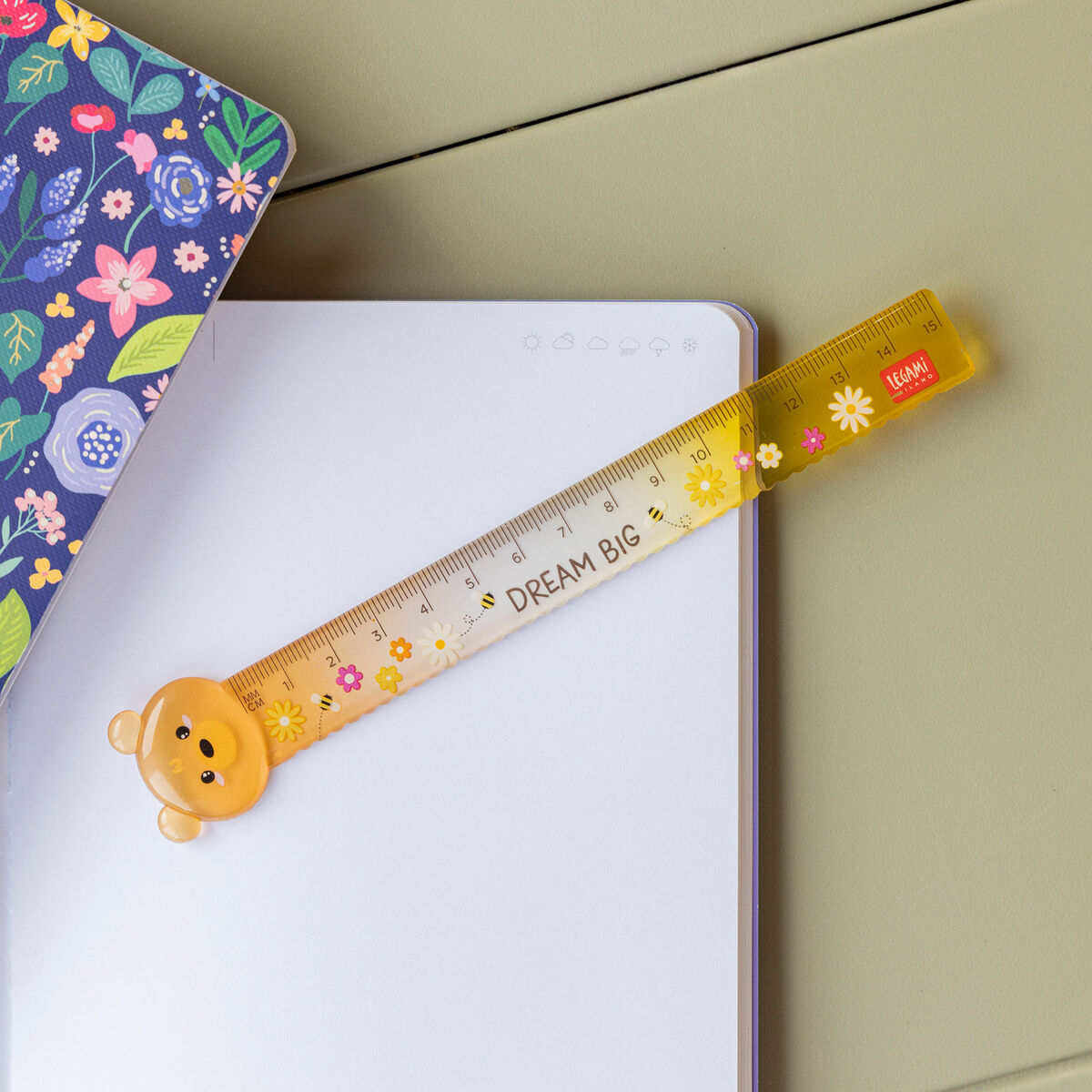 Yellow ruler with bear design on a notebook