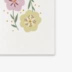Floral design with pink and yellow flowers on a white background