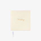 Cream-colored notebook with 'Wedding' in gold text o