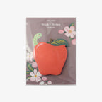 Sticky notes with an apple design on a grey background