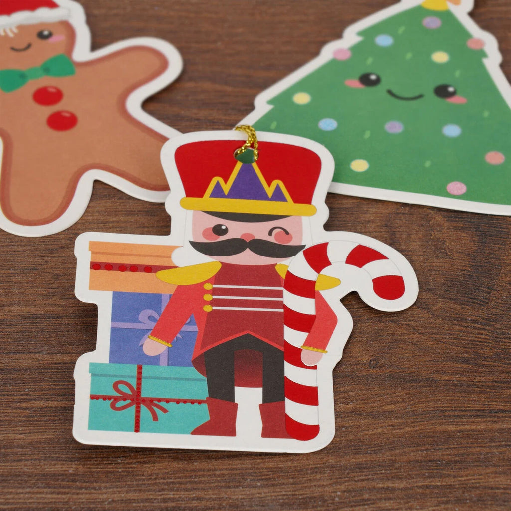 Christmas-themed gift tags including a nutcracker, gingerbread man, and tree on a wooden surface.