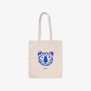 Beige tote bag with blue tiger face design on a white background