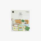 Packaged product with cute sticker illustrations of cats and a shamrock on a white background