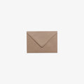A closed C7 brown kraft v-flap envelope.