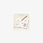 Vinyl sticker with stationery items, Kartotek Copenhagen logo and 'Take your time' text on a white background