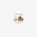 Vinyl sticker with a illustration of a cargo bike and the text 'Copenhagen, best by bike' on a white background