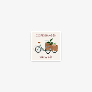Vinyl sticker with a illustration of a cargo bike and the text 'Copenhagen, best by bike' on a white background