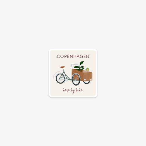 Vinyl sticker with a illustration of a cargo bike and the text 'Copenhagen, best by bike' on a white background
