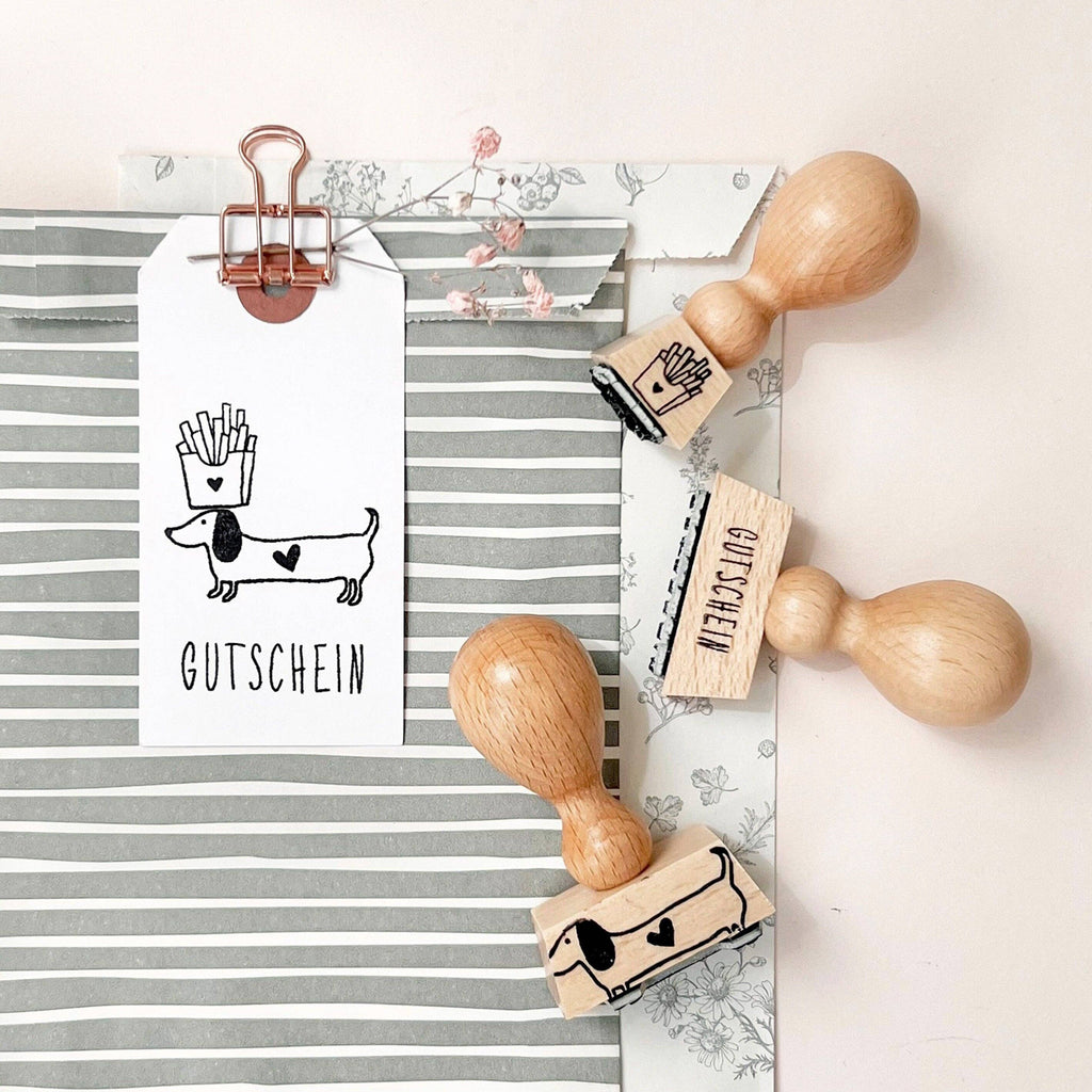Wooden stamps with printed designs on a striped paper and white background