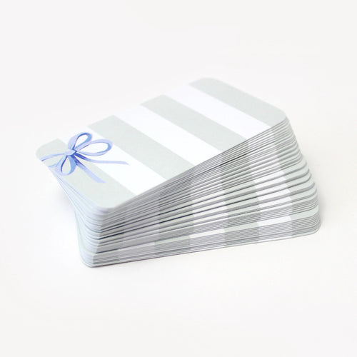 Stack of pocket cards with a blue bow on a white background