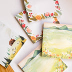 Set of sticky notes with nature-themed illustrations on a white surface.