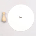 Wooden rubber stamp with the text 'love'