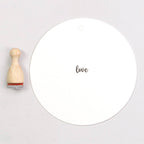 Wooden rubber stamp with the text 'love'