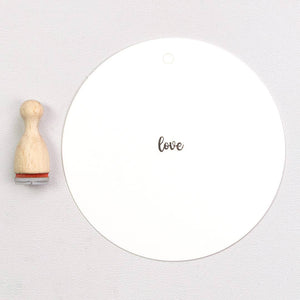 Wooden rubber stamp with the text 'love'