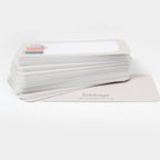 Stack of white cards with a book stack illustration and 'inklings' branding on a white background