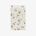 Paper bag with a green leaf pattern on a white background