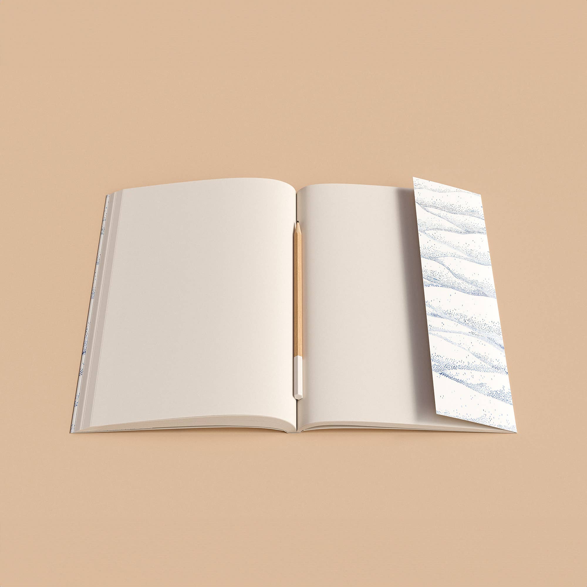 Open notebook with a pen on a beige background